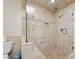 Bathroom featuring a seamless glass shower, tiled walls, and recessed lighting at 2460 Due West Nw Cir, Kennesaw, GA 30152
