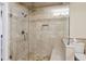 Modern walk-in shower featuring neutral tile, a glass door, a bench, and dual shower heads at 2460 Due West Nw Cir, Kennesaw, GA 30152