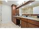 Bathroom featuring a double vanity, granite countertop, and a seamless glass shower at 2460 Due West Nw Cir, Kennesaw, GA 30152