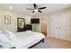 Bedroom with a ceiling fan, television, carpeted floor, and access to closet and bathroom at 2460 Due West Nw Cir, Kennesaw, GA 30152