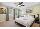 Bedroom with ceiling fan, window views, and bedside lamps provides a relaxing atmosphere at 2460 Due West Nw Cir, Kennesaw, GA 30152