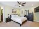 Comfortable bedroom featuring a ceiling fan, plush carpeting, and stylish dark furniture at 2460 Due West Nw Cir, Kennesaw, GA 30152
