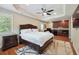 A well-lit bedroom featuring hardwood floors and an entertainment area complete with a wet bar at 2460 Due West Nw Cir, Kennesaw, GA 30152