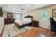 Well-lit main bedroom featuring a large plush bed, ample closet space, and outdoor access at 2460 Due West Nw Cir, Kennesaw, GA 30152