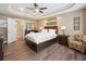 A beautifully staged bedroom features a plush bed, wood floors, and a cozy sitting area at 2460 Due West Nw Cir, Kennesaw, GA 30152