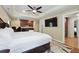 This bright bedroom has wood floors, a large bed, kitchenette, workspace, and ensuite bathroom at 2460 Due West Nw Cir, Kennesaw, GA 30152