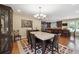 Open-concept dining area featuring a large table and a view into the modern kitchen at 2460 Due West Nw Cir, Kennesaw, GA 30152