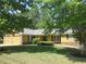 Charming home featuring a well-manicured lawn, attached two-car garage, and a blend of stone and siding accents at 2460 Due West Nw Cir, Kennesaw, GA 30152