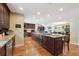 Spacious kitchen with dark wood cabinetry, a large center island, and stainless steel appliances, perfect for cooking at 2460 Due West Nw Cir, Kennesaw, GA 30152