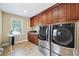 Well-equipped laundry room with modern appliances, dark cabinetry, granite countertops and lots of storage space at 2460 Due West Nw Cir, Kennesaw, GA 30152