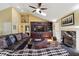 Cozy living room with a fireplace, vaulted ceiling, and custom built-ins, perfect for relaxing and entertaining guests at 2460 Due West Nw Cir, Kennesaw, GA 30152
