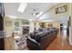 Bright living room with vaulted ceilings, skylights, a fireplace, and custom built-ins, offering a cozy atmosphere at 2460 Due West Nw Cir, Kennesaw, GA 30152