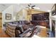 Living room featuring vaulted ceilings, custom built-ins and hardwood floors at 2460 Due West Nw Cir, Kennesaw, GA 30152