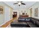 Open-concept living area featuring a leather sectional sofa, hardwood flooring, and seamless flow to adjacent rooms at 2460 Due West Nw Cir, Kennesaw, GA 30152