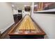Spacious recreation room featuring a Champion shuffleboard table for endless entertainment and friendly competitions at 2460 Due West Nw Cir, Kennesaw, GA 30152