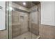 Walk-in shower with granite tile and glass door at 2460 Due West Nw Cir, Kennesaw, GA 30152