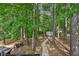Serene backyard view with lush greenery, walking path and shed, offering a tranquil escape at 4035 Woodbridge Ct, Powder Springs, GA 30127