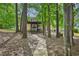 Beautiful backyard with mature trees, providing shade and privacy to a home with rear deck at 4035 Woodbridge Ct, Powder Springs, GA 30127