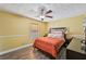 A sunlit bedroom is styled with a bed, modern decor, and warm yellow walls at 4035 Woodbridge Ct, Powder Springs, GA 30127