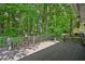 A large deck with wood railings overlooks a lush backyard, providing privacy and serenity at 4035 Woodbridge Ct, Powder Springs, GA 30127