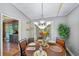 Charming dining room with hardwood floors, bright chandelier, and decorative place settings at 4035 Woodbridge Ct, Powder Springs, GA 30127