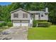 Charming two-story home with a well-manicured lawn and a two-car garage at 4035 Woodbridge Ct, Powder Springs, GA 30127