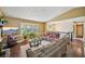 Comfortable living room with large windows, neutral decor, and hardwood floors at 4035 Woodbridge Ct, Powder Springs, GA 30127