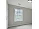 Neutral bedroom offers a window with a view and carpet flooring at 463 The Gables Dr, Mcdonough, GA 30253