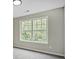 Bright bedroom features a large window with a view of lush greenery at 463 The Gables Dr, Mcdonough, GA 30253