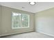 Bedroom with neutral walls, carpet flooring, and natural light from the large window at 463 The Gables Dr, Mcdonough, GA 30253