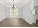 Clean dining room with new floors, chair rail, and a stylish chandelier that adds a touch of elegance at 463 The Gables Dr, Mcdonough, GA 30253