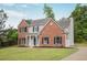 Angle view of a home featuring a combination of brick and siding, complemented by black shutters and a well-maintained lawn at 463 The Gables Dr, Mcdonough, GA 30253