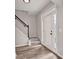 Bright foyer showcasing new floors, stairs with a black railing, and natural light from side panel windows around the front door at 463 The Gables Dr, Mcdonough, GA 30253