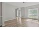 Bright living room features new floors, neutral walls, and a view into the home's entry foyer at 463 The Gables Dr, Mcdonough, GA 30253