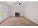 Cozy living room featuring new floors, a ceiling fan and a fireplace at 463 The Gables Dr, Mcdonough, GA 30253