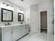 Main bathroom features a double sink vanity, marble tile floors, and access to the closet at 463 The Gables Dr, Mcdonough, GA 30253