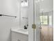 Small powder room features a white vanity with black hardware and a wall mirror at 463 The Gables Dr, Mcdonough, GA 30253