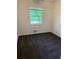 Bedroom with plush gray carpeting and a bright window for natural light and ventilation at 1234 Carolyn St, Marietta, GA 30062