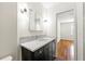 This bathroom offers a stylish vanity with marble countertop and modern lighting fixtures at 1622 Executive Park Ne Ln, Atlanta, GA 30329