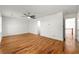 An open bedroom has a ceiling fan, hardwood floors, and a view to the upstairs hallway at 1622 Executive Park Ne Ln, Atlanta, GA 30329