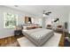 This bedroom features hardwood floors, a ceiling fan, and abundant natural light from the bright windows at 1622 Executive Park Ne Ln, Atlanta, GA 30329