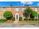 Charming brick townhome featuring meticulously landscaped front yard and elegant entryway at 1622 Executive Park Ne Ln, Atlanta, GA 30329