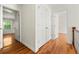 Upstairs hallway with hardwood floors, storage closet and access to bedrooms with white trim at 1622 Executive Park Ne Ln, Atlanta, GA 30329