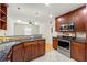 Well-lit kitchen with stainless steel appliances, dark countertops, and wood cabinets at 1622 Executive Park Ne Ln, Atlanta, GA 30329