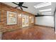 Spacious sunroom with brick walls, ceiling fans, tiled floor, and access to the outdoors at 1622 Executive Park Ne Ln, Atlanta, GA 30329