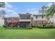 Large backyard with a deck, sunroom, and lush greenery, showcasing the outdoor living space and the home's appeal at 2855 Cedar Canyon Ct, Atlanta, GA 30345