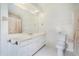 Bathroom with a white vanity, decorative wallpaper, and a shower-tub combination, creating a cozy atmosphere at 2855 Cedar Canyon Ct, Atlanta, GA 30345