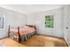 Bedroom with wood floors, a window letting in natural light, and a classic bed frame adds warmth to the room at 2855 Cedar Canyon Ct, Atlanta, GA 30345
