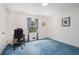 Bright bedroom with blue carpet, a window with curtains, and white walls, perfect for a home office or guest room at 2855 Cedar Canyon Ct, Atlanta, GA 30345