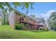 Two-story brick home featuring a backyard deck, a sunroom, and a well-maintained lawn with landscaping at 2855 Cedar Canyon Ct, Atlanta, GA 30345